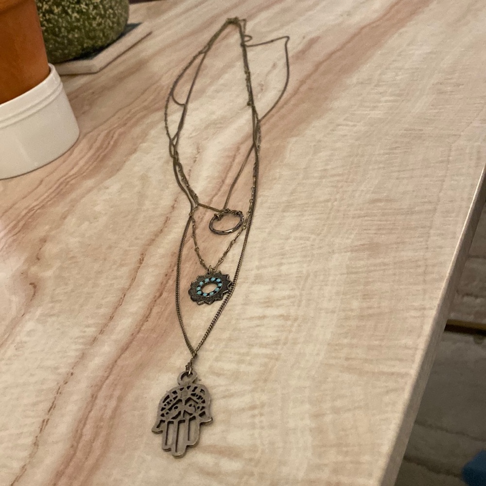 Tri-layered necklace with hamsa (hand), sunburst and circle charms